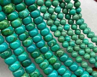 May include: Multiple strands of turquoise-colored beads in varying sizes and shapes. The left strands feature larger, cylindrical, slightly flattened beads with marbled textures, while the right strands consist of smaller, smooth, round beads.