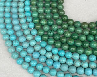 May include: Multiple strands of round beads arranged in a curved pattern. The beads feature a gradient of colors ranging from bright turquoise blue with dark veining to deep forest green with subtle natural variations in texture and tone.
