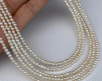 May include: A multi-strand necklace featuring small, off-white, irregularly shaped freshwater pearls. The strands are arranged in a cascading layered design, showcasing the natural texture and luster of the individual pearl beads.