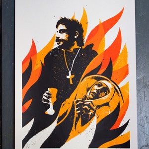 May include: A black and white screen print of a man and a woman against a fiery orange and yellow background. The man is holding a glass and the woman is holding her hands together. The print is signed and numbered 29/50.