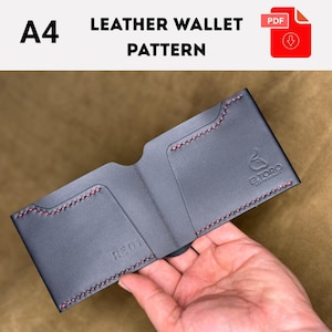 May include: A black leather wallet pattern with red stitching. The wallet is open, showing card slots and a bill compartment. The text "A4 LEATHER WALLET PATTERN" is at the top, with a PDF icon. The wallet has the logo "E.TORO LEATHERCRAFT".