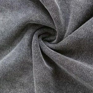 a close-up view of a wrinkled gray fabric, possibly denim or a similar type of material.