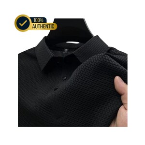 May include: Black textured dress shirt with a classic collar and button-down front. The shirt is displayed on a hanger. A gold and blue badge in the upper left corner reads "100% AUTHENTIC".