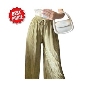 May include: Pleated wide-leg pants in a light olive green color with a drawstring waist. A white handbag with a curved handle is held in the right hand. A red and white "BEST PRICE" sticker is in the upper left corner.