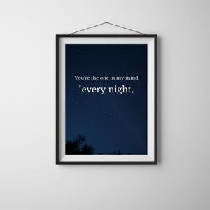 May include: A black framed print with a dark blue night sky background and white stars. The print features the text "You're the one in my mind every night."