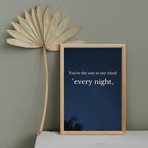 May include: A framed print with a dark blue background and white stars. The text "You're the one in my mind *every night." is printed in white on the print.