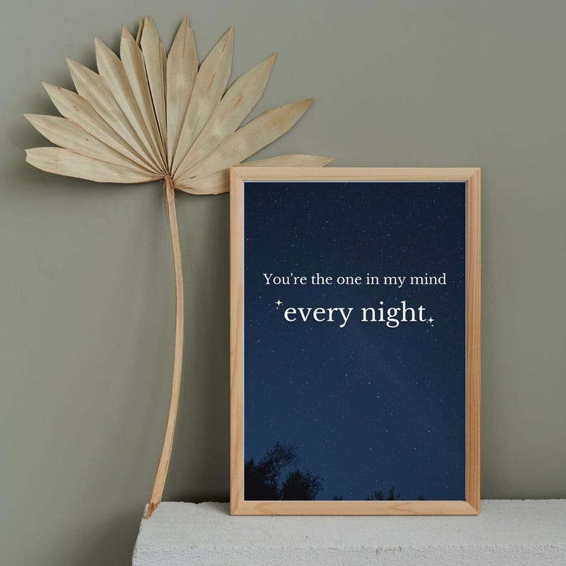 May include: A framed print with a dark blue background and white stars. The text "You're the one in my mind *every night." is printed in white on the print.