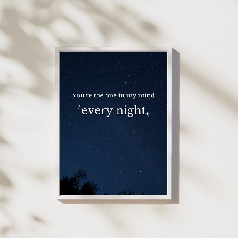 May include: A white framed print with a dark blue night sky background filled with stars. The text on the print reads "You're the one in my mind *every night.*"