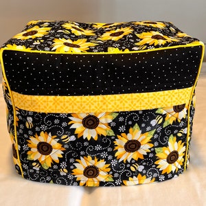 May include: Black and yellow quilted bread maker cover with a sunflower and bee design.