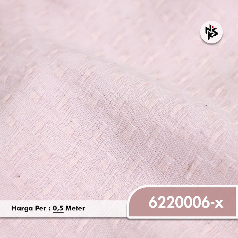 May include: Close-up of a light pink fabric with a textured, repeating square pattern. The fabric is slightly folded, showing depth and dimension. The image includes the text "6220006-x".