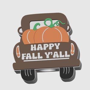 May include: A brown truck carrying two orange pumpkins with green vines. The truck has the words "HAPPY FALL Y'ALL" in white. The design is a fall-themed decoration.
