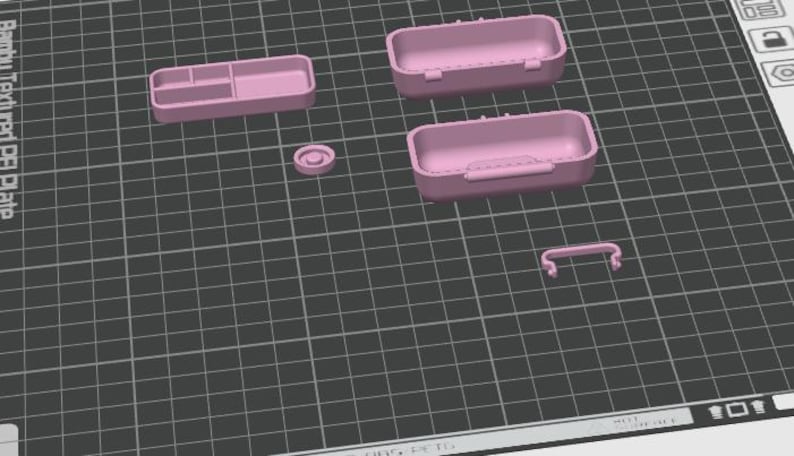 May include: A collection of pink 3D-printed storage containers and accessories. The set includes two rectangular boxes with hinged lids, a small tray with compartments, a circular piece, and a handle. The items are arranged on a grid.