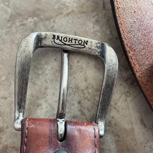 May include: A set of three ceramic vases in varying heights and shapes. The vases are glazed in a matte white finish, offering a minimalist aesthetic. The tallest vase measures approximately 10 inches in height.