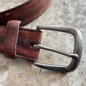 May include: A set of three ceramic mugs with a speckled, matte finish. The mugs are in shades of cream, light gray, and dark gray. Each mug has a simple, minimalist design, perfect for coffee or tea.