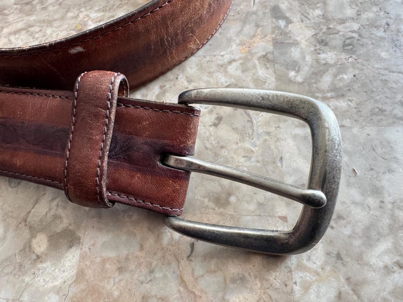 May include: A set of three ceramic mugs with a speckled, matte finish. The mugs are in shades of cream, light gray, and dark gray. Each mug has a simple, minimalist design, perfect for coffee or tea.