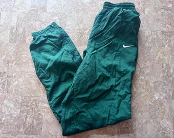 Vintage Nike trainingsbroek windjack baggy heren XS groen rits enkels nylon jaren 90. Taille plat: 11-16" uitgerekt