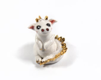 Hand sculpted porcelain dragon figurine with 24k gold trim by Anita Reay