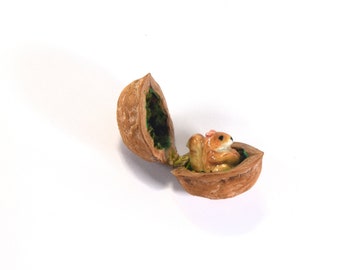 Miniature ceramic red squirrel baby in a walnut shell figurine, hand sculpted by Anita Reay