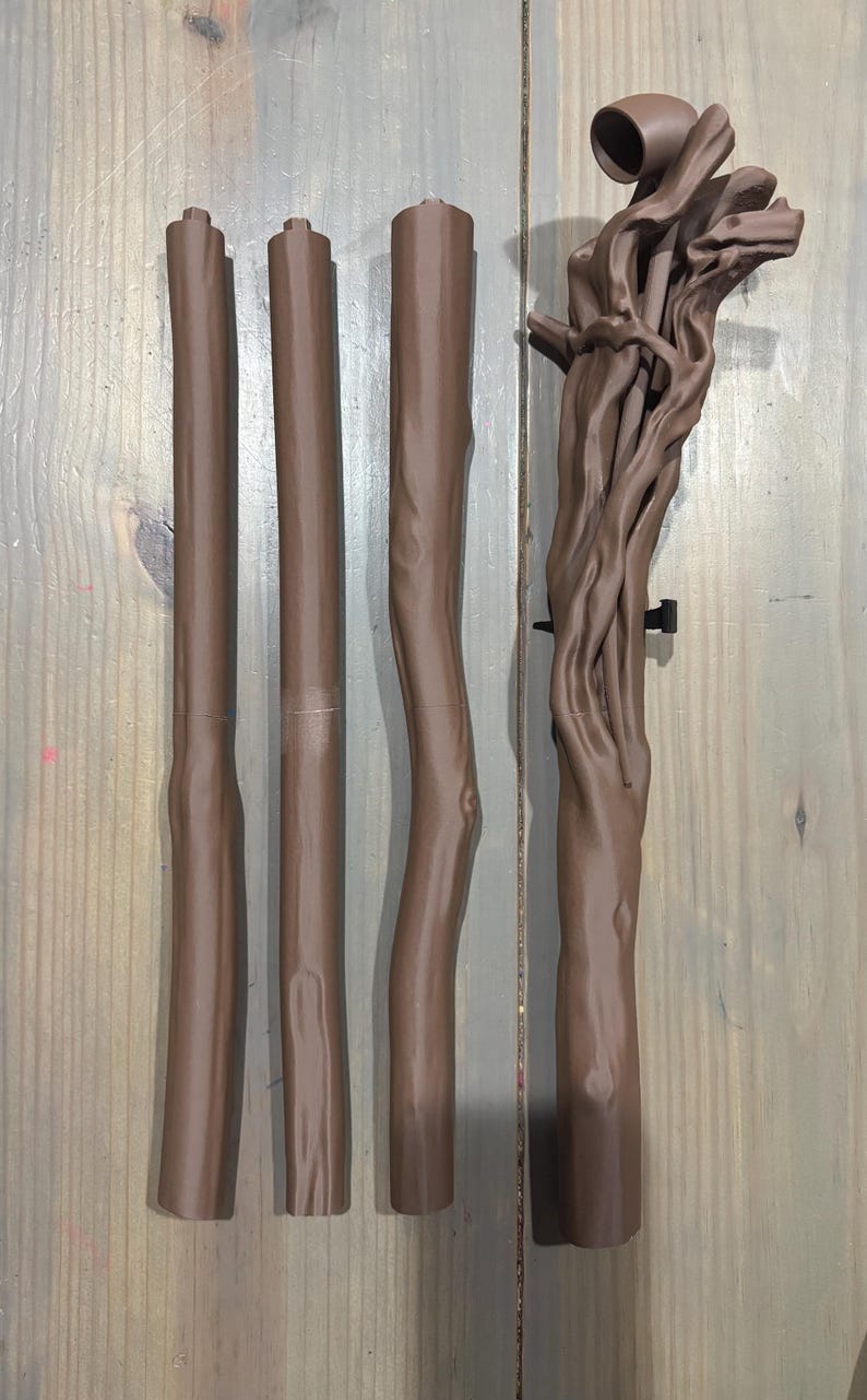 May include: A collection of brown, tree-like components, likely for a decorative or functional item. The pieces vary in shape and size, with some appearing to be straight poles and others more organically shaped. The color is a consistent, warm brown.