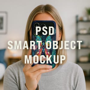 May include: A smartphone case with a colorful butterfly design is held in front of a person's face. The case has a dark blue border and a vibrant illustration of a butterfly with green, pink, and yellow wings. The words "PSD SMART OBJECT MOCKUP" are overlaid on the image.