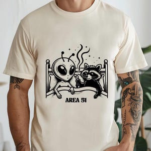 Alien and Racoon Tshirt, Unisex Area 51, Funny, Gifts for him or her. Men. Raccoon, Unusual, Weird, Graphic tee, Ufo, Meme, Animal, Unhinged