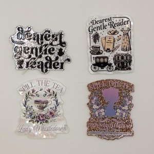 May include: Four decorative glittery stickers with text and illustrations. One says "Dearest Gentle Reader" with a quill. Another says "Dearest Gentle Reader" with a carriage and dress. The other two say "Spill the Tea" with a teacup and silhouette.
