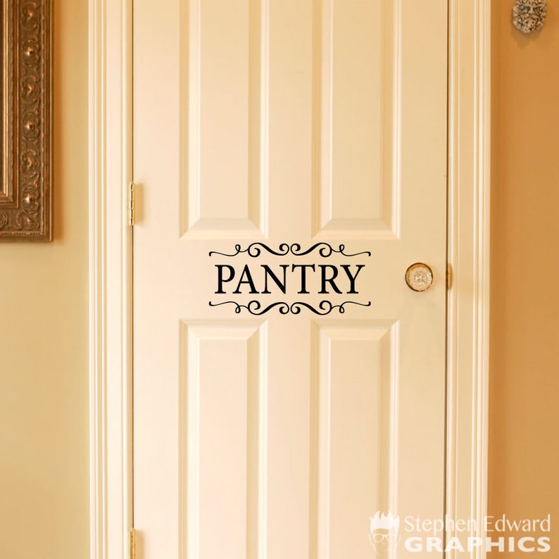 May include: A white door with a black vinyl decal that says "PANTRY" with decorative flourishes.