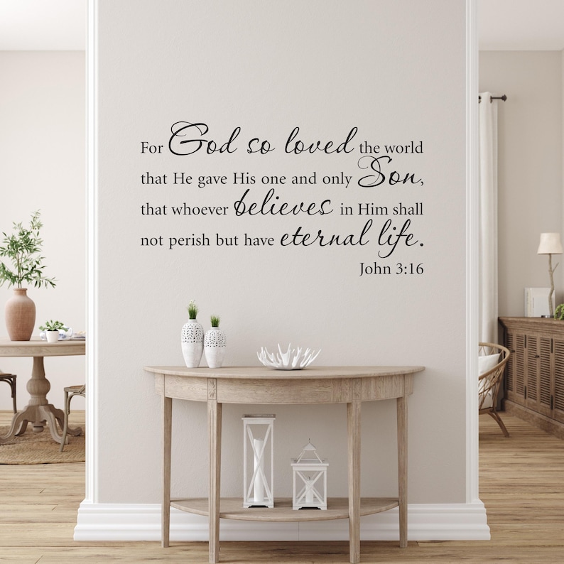 John 3:16 wall decal in black vinyl displayed in an elegant entryway above a wooden table with white decor accents.