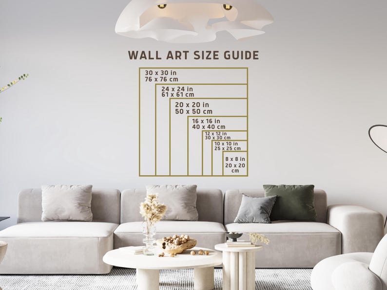 K&ouml;nnte beinhalten: Ein Wandkunst-Gr&ouml;&szlig;enleitfaden mit verschiedenen Gr&ouml;&szlig;en in Zoll und Zentimetern. Der Leitfaden ist auf einer wei&szlig;en Wand mit einem hellbraunen Rahmen gedruckt.