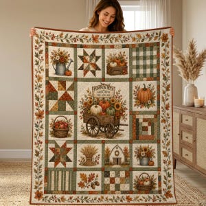 May include: A rectangular quilt featuring a patchwork design with autumn-themed illustrations including pumpkins, sunflowers, wheat sheaves, and a wooden wagon with a sign reading PUMPKIN PATCH FARM FRESH PICK YOUR OWN, all bordered by fall leaves.