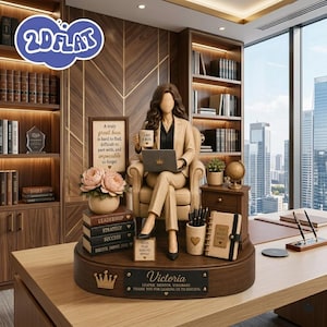 May include: A figurine of a person in a tan suit sitting in a chair, holding a mug labelled 'LIKE A BOSS' and a laptop. The base features a plaque reading 'Victoria' and 'LEADER, MENTOR, VISIONARY, THANK YOU FOR LEADING US TO SUCCESS' with a crown icon.