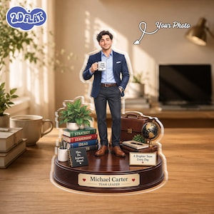 May include: A custom acrylic desk display featuring a figure of a man in a navy blazer and dark trousers holding a mug. The base is wood-toned with a plaque reading Michael Carter Team Leader, surrounded by miniature books, a briefcase, and a globe.
