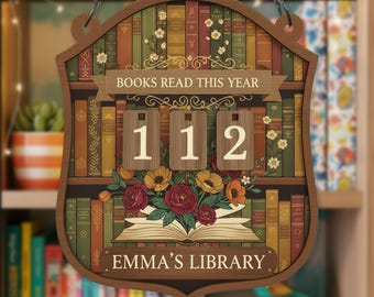 May include: Wooden sign with a bookshelf design, featuring the text "BOOKS READ THIS YEAR" and the numbers "112". The sign also includes the text "EMMA'S LIBRARY" and a floral arrangement.