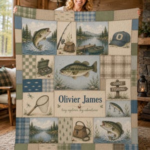 May include: A patchwork quilt featuring fishing-themed illustrations including bass, a fishing rod, a tackle box, a net, a hat, and a boat. The center panel displays the text "Olivier James" and "tiny explorer, big adventures" in blue.