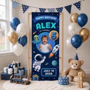 May include: A vertical navy blue birthday banner featuring the text Happy Birthday Alex is Turning 5 and July 10 2026. The design includes a central photo of a child, an astronaut, a rocket, an alien in a saucer, and planets on a starry background.