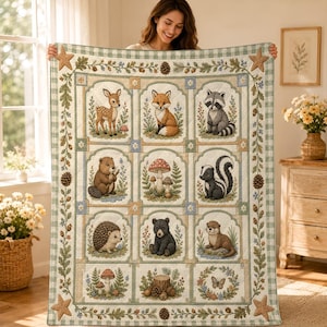 May include: A quilt featuring a grid of woodland animals including a deer, fox, raccoon, beaver, skunk, hedgehog, bear, and otter, alongside mushrooms and a butterfly. The border is decorated with pinecones, leaves, and four tan starfish.