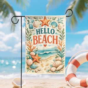 May include: A rectangular garden flag hanging on a black metal stand, featuring the text HELLO BEACH in blue and orange. The design includes illustrations of orange starfish, various seashells, green seaweed, and a sandy beach with blue ocean waves.
