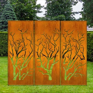 May include: Three rust-colored metal panels with a cut-out design of trees. The panels are standing upright in a grassy area.