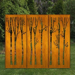 May include: A three-panel outdoor screen with a rust-colored finish. Each panel features a cut-out design of stylized trees with branches and leaves. The screen is set against a backdrop of green foliage and grass.