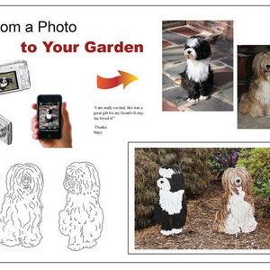 May include: A black and white dog statue with a fluffy tail and a black and white dog statue with a brown and white fluffy tail. The statues are standing on a bed of brown mulch and green plants.