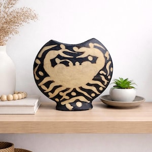 May include: A set of three ceramic mugs with a speckled, matte finish in cream, light grey, and dark grey. Each mug has a simple, minimalist design, ideal for tea or coffee.