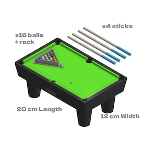 May include: A miniature pool table with a green felt surface, black frame, and four black legs. Includes a set of 16 balls, a rack, and four cue sticks. The table measures 20 cm in length and 12 cm in width.