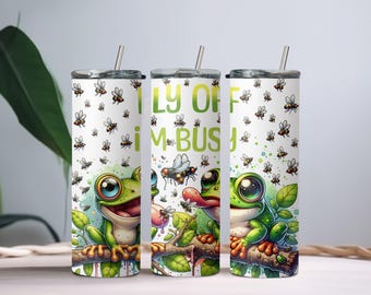 May include: Three stainless steel tumblers with a white background and a green frog design. The tumblers have a green frog sitting on a branch with flies around it. The text on the tumblers reads "Fly off I'm busy".