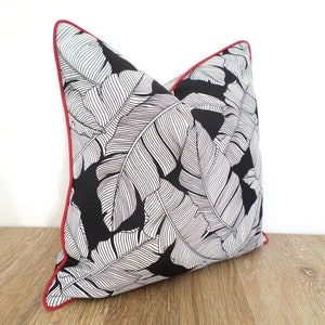 black outdoor pillow with tropical palm leaf print