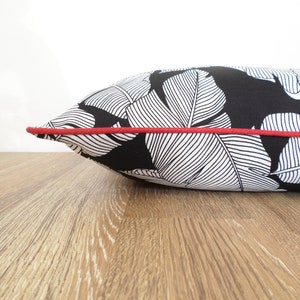 black and white outdoor pillow with red piping for contrast modern patio decor