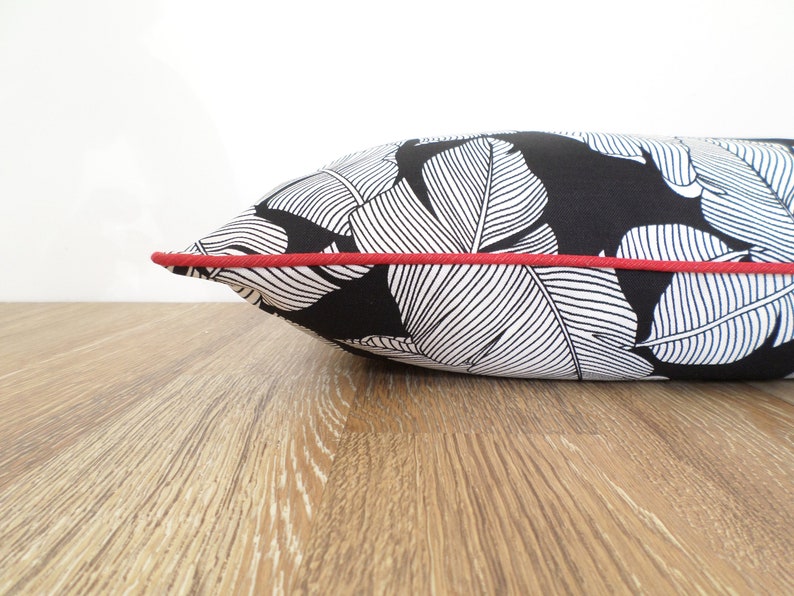 black and white outdoor pillow with red piping for contrast modern patio decor