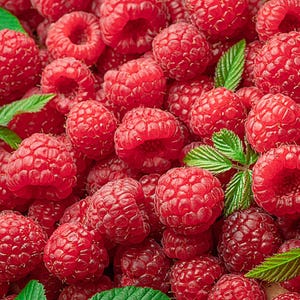 May include: A close-up shot of a pile of fresh, ripe raspberries. The berries are a vibrant red color, with a textured surface and a slightly fuzzy appearance. Green leaves are scattered throughout the pile, adding a touch of contrast.