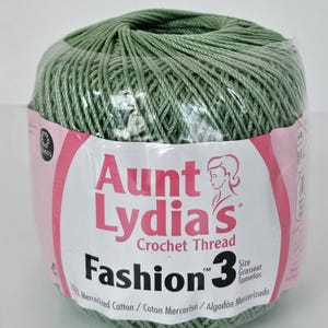May include: Aunt Lydia's Fashion 3 crochet thread in a light green hue. The label features the brand name, product details, and a woman's silhouette. The thread is 100% mercerized cotton and is wrapped in clear plastic.