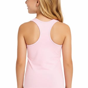 May include: A light pink racerback tank top. The tank top is made of a soft material and has a scoop neck. The back of the tank top is visible, and the straps are thin. The model is wearing black shorts.