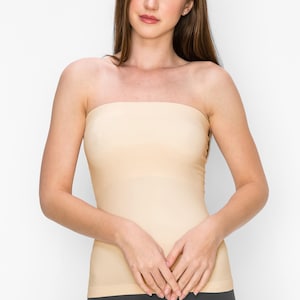 May include: A nude-colored strapless tube top made of a smooth, stretchy fabric. The top is fitted and has a seamless design.